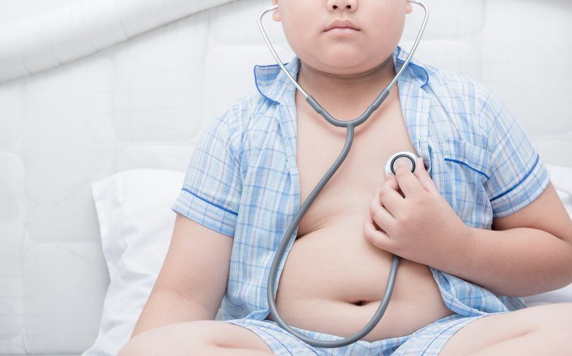 Obese boy listens to his heart