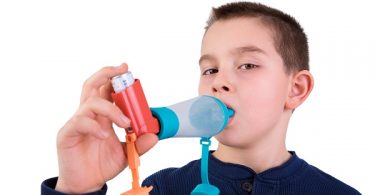 Kid Using Inhaler With Spacer