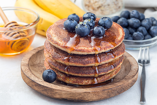 Banana oat pancakes with honey and blueberry