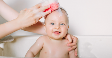 Baby smiling getting a sponge bath